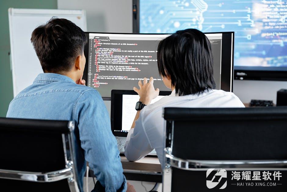 Two developers working together in an office, discussing code on a screen. Technology teamwork setting.