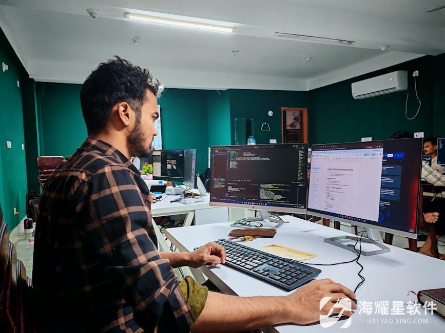Software developer coding on dual monitors in a well-lit modern office, focused and engaged.