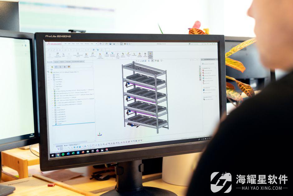 Close-up of an engineer using CAD software for vertical farm design on a desktop computer.