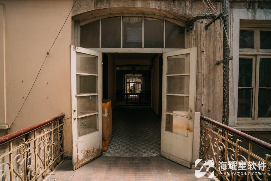 Vintage building exterior with open doors leading to a nostalgic hallway.