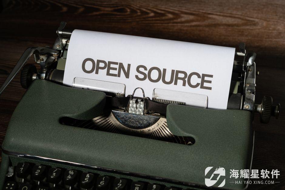 Close-up of a vintage typewriter displaying the text 'Open Source' on paper.